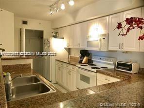 3606 South Ocean Boulevard, Unit 504 Highland Beach, FL 33487 - Photo 9 of 26 a kitchen with a sink and a stove top oven
