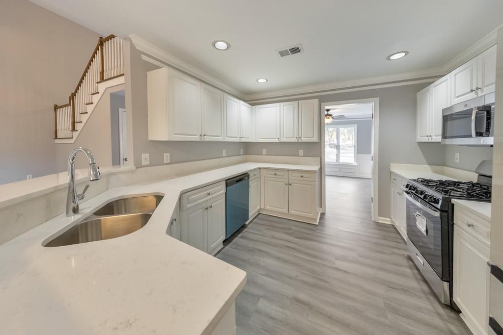 4804 Thicket Path Northwest Acworth, GA 30102 - Photo 16 of 48 a kitchen with a sink a stove and cabinets
