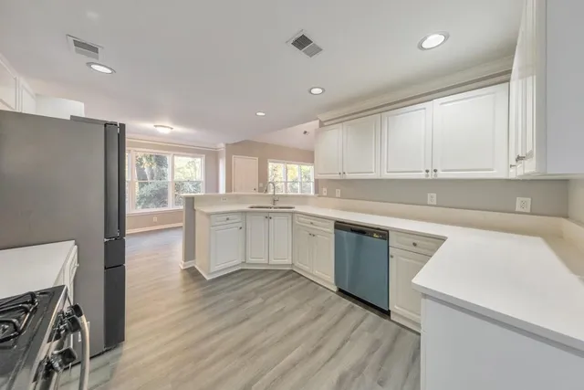 a kitchen with a sink window and cabinets