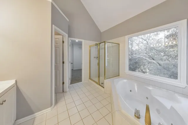 a spacious bathroom with a bathtub and a shower