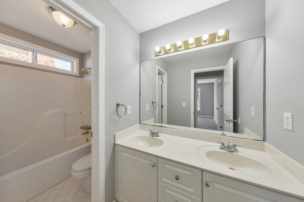 4804 Thicket Path Northwest Acworth, GA 30102 - Photo 32 of 48 a bathroom with a sink a toilet a shower and a mirror