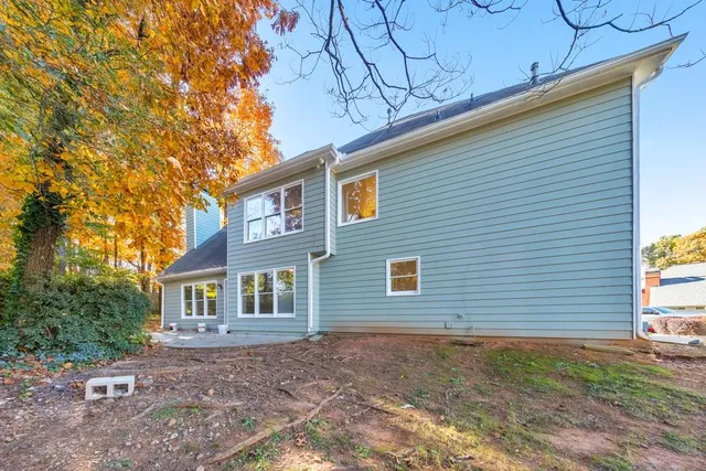 a view of a backyard with large trees