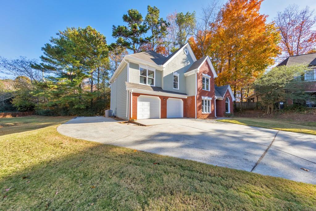 4804 Thicket Path Northwest Acworth, GA 30102 - Photo 42 of 48 a front view of a house with a yard and garage