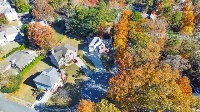 a view of a white house with a large windows yard and a large tree