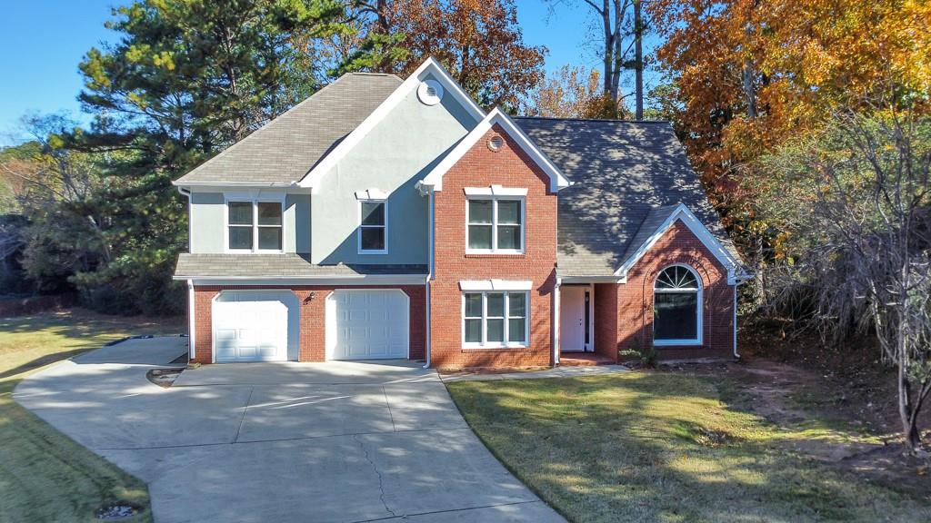 4804 Thicket Path Northwest Acworth, GA 30102 - Photo 45 of 48 a view of a white house with a large windows yard and a large tree