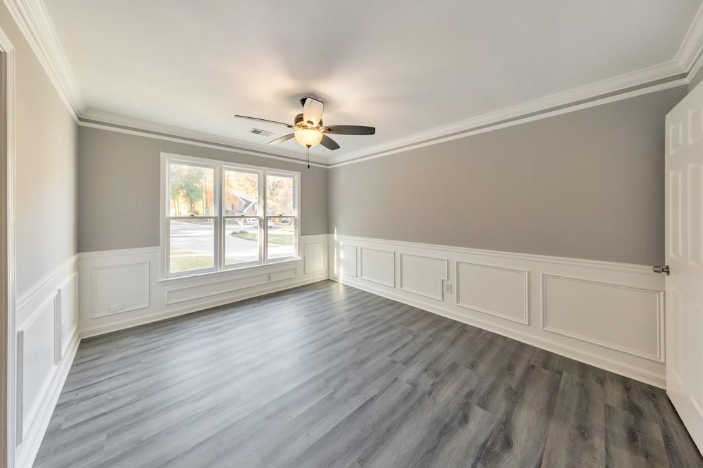 4804 Thicket Path Northwest Acworth, GA 30102 - Photo 7 of 48 an empty room with wooden floor chandelier fan and windows