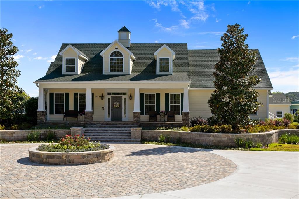 Front View with Paver Circular Driveway and Custom Ledgestone