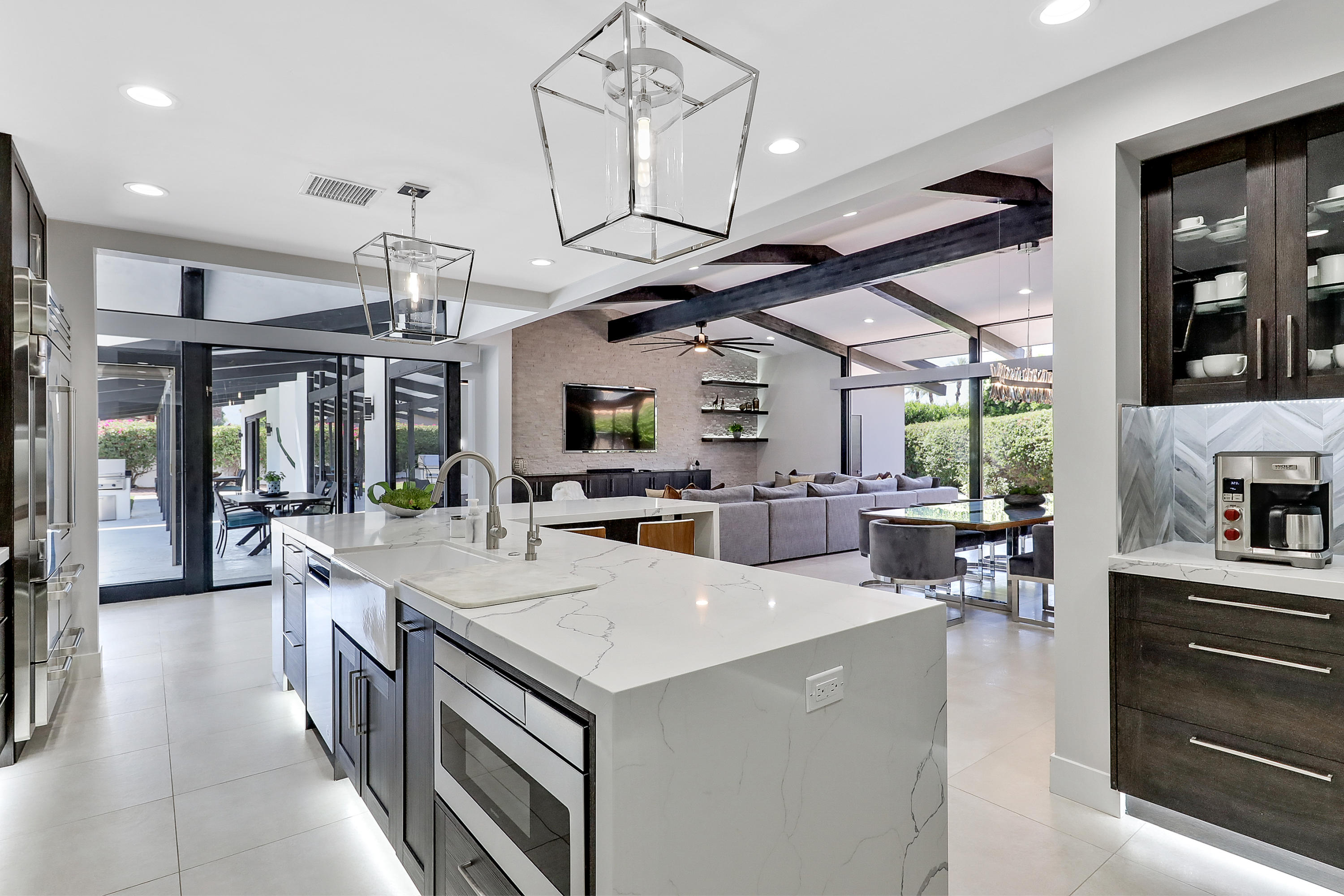 45731 Paradise Valley Road Indian Wells, CA 92210 - Photo 12 of 41 a open kitchen with stainless steel appliances kitchen island granite countertop a sink and cabinets