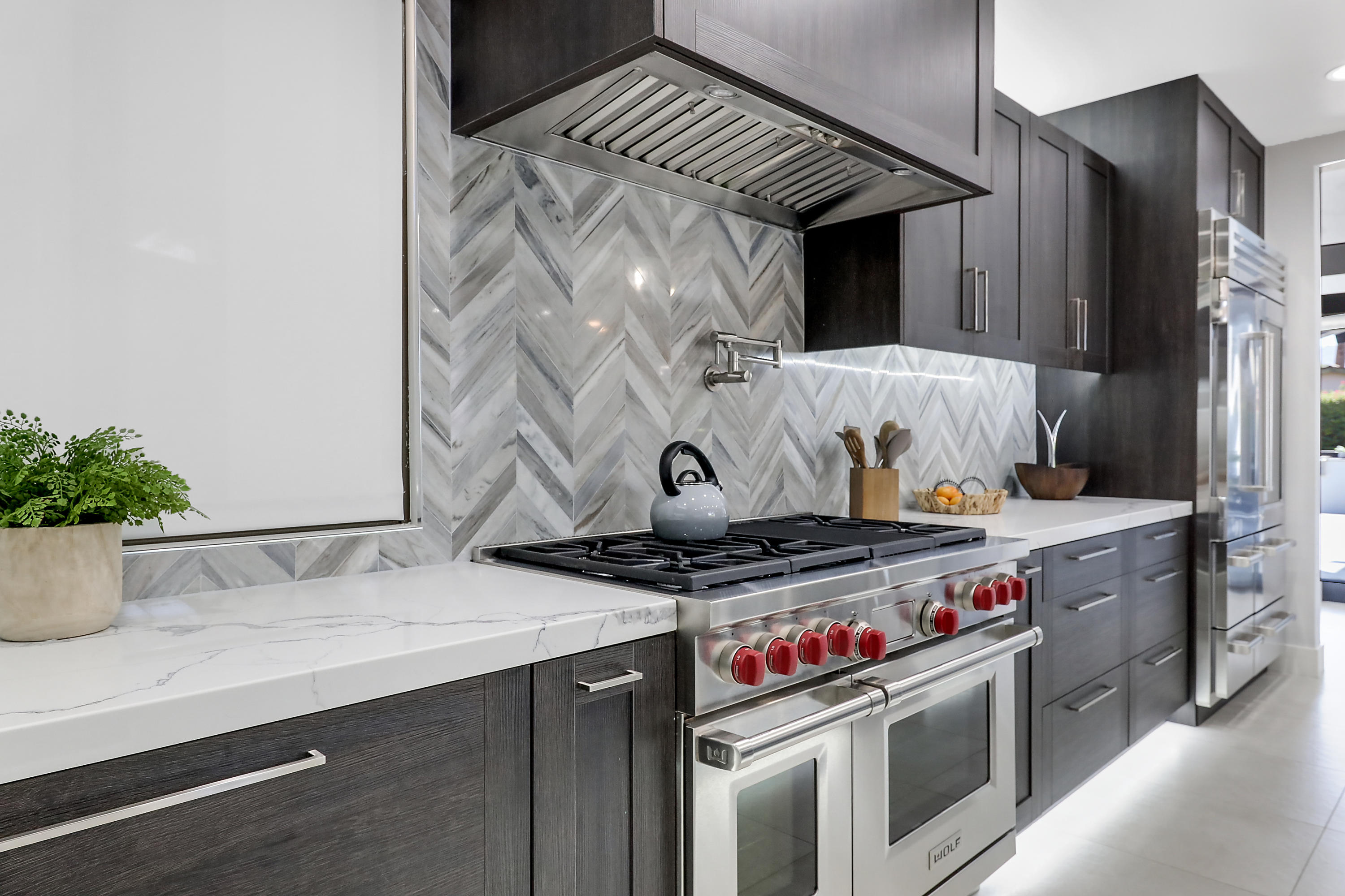 45731 Paradise Valley Road Indian Wells, CA 92210 - Photo 14 of 41 a kitchen with stainless steel appliances granite countertop a stove and a microwave