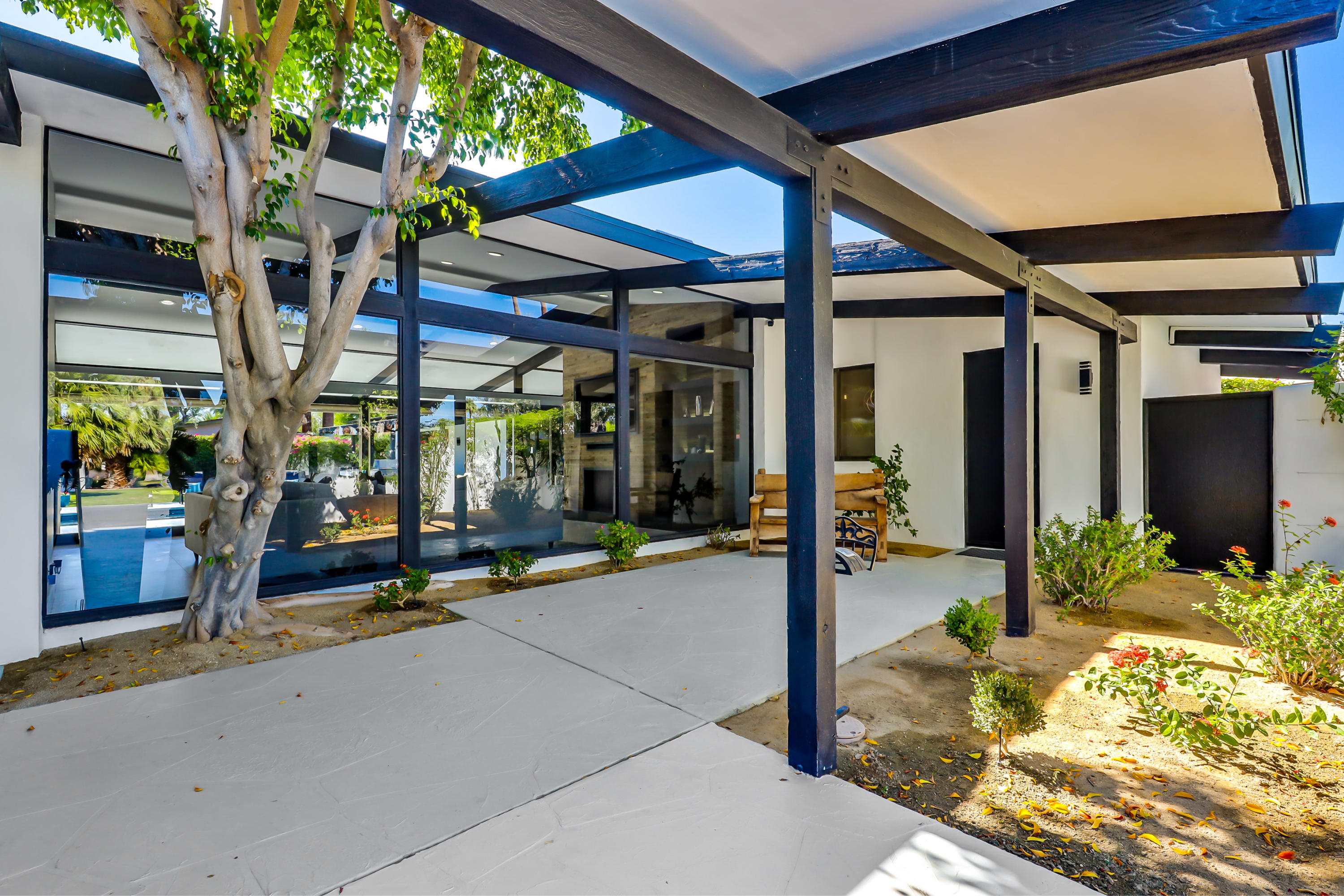 45731 Paradise Valley Road Indian Wells, CA 92210 - Photo 3 of 41 a view of a patio with table and chairs under an umbrella