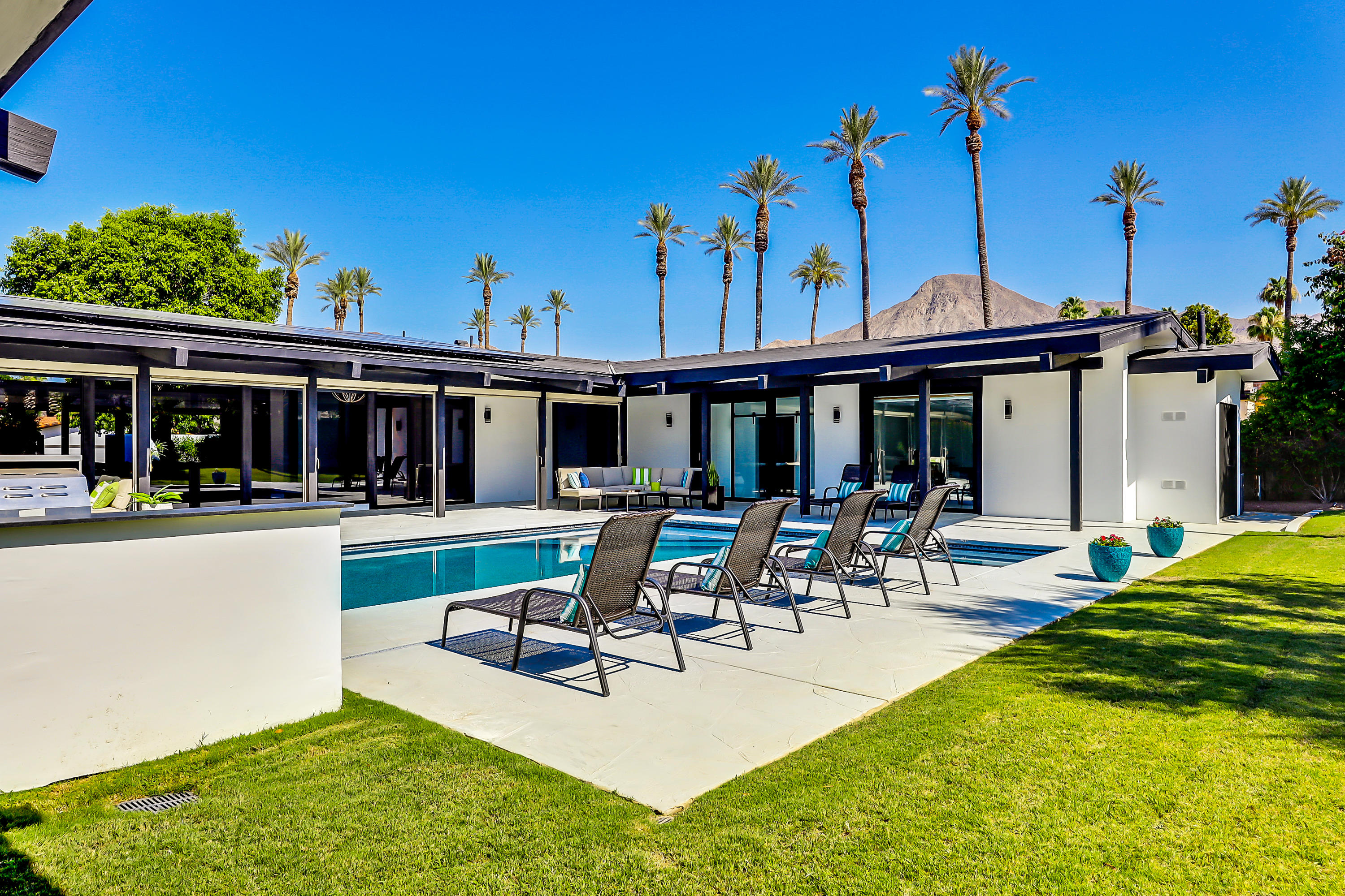 45731 Paradise Valley Road Indian Wells, CA 92210 - Photo 21 of 41 a view of a house with swimming pool and sitting area