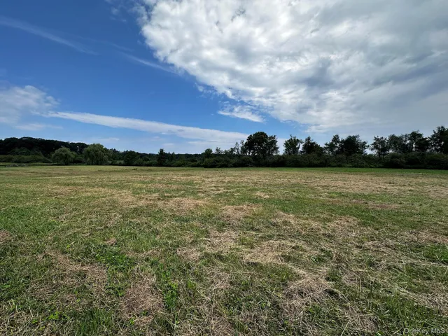 a view of a ocean with sunset in the background