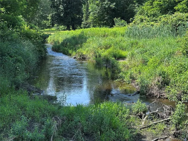 a view of a lake view with houses in back