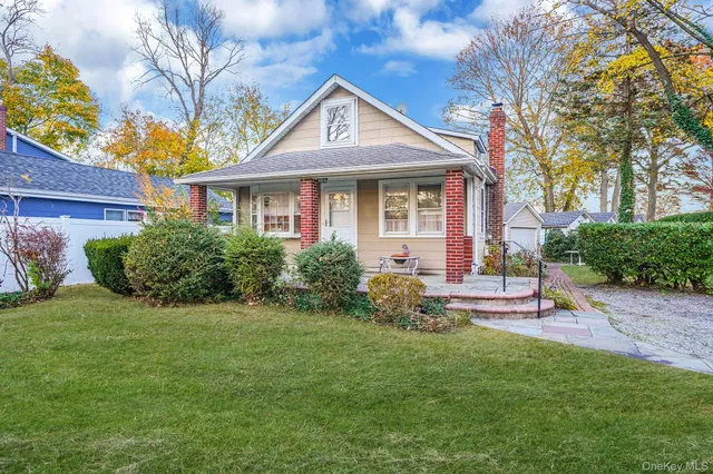 a front view of a house with a yard and porch