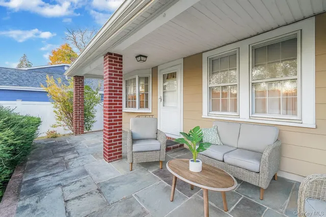 a view of a house with a couches chair and a potted plant