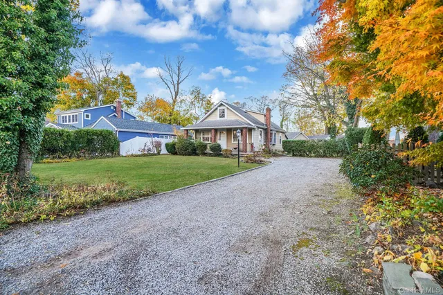 a view of house with a yard