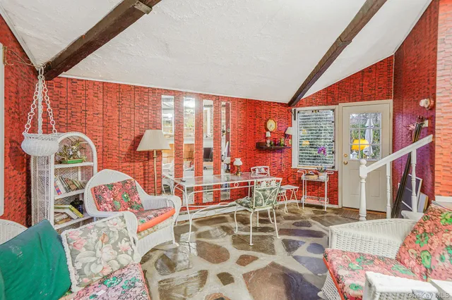 a living room with furniture and a floor to ceiling window