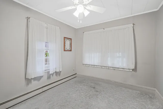 an empty room with windows and entrance