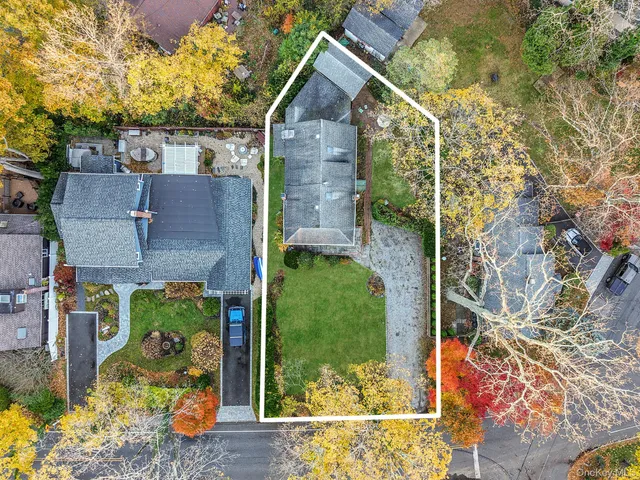 an aerial view of a house with a yard