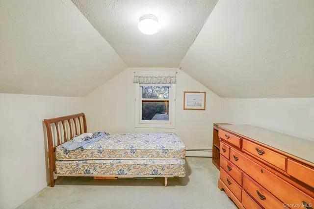 a spacious bedroom with a bed and a window