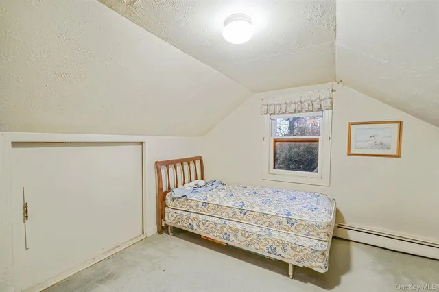 a bedroom with a bed and wall painting