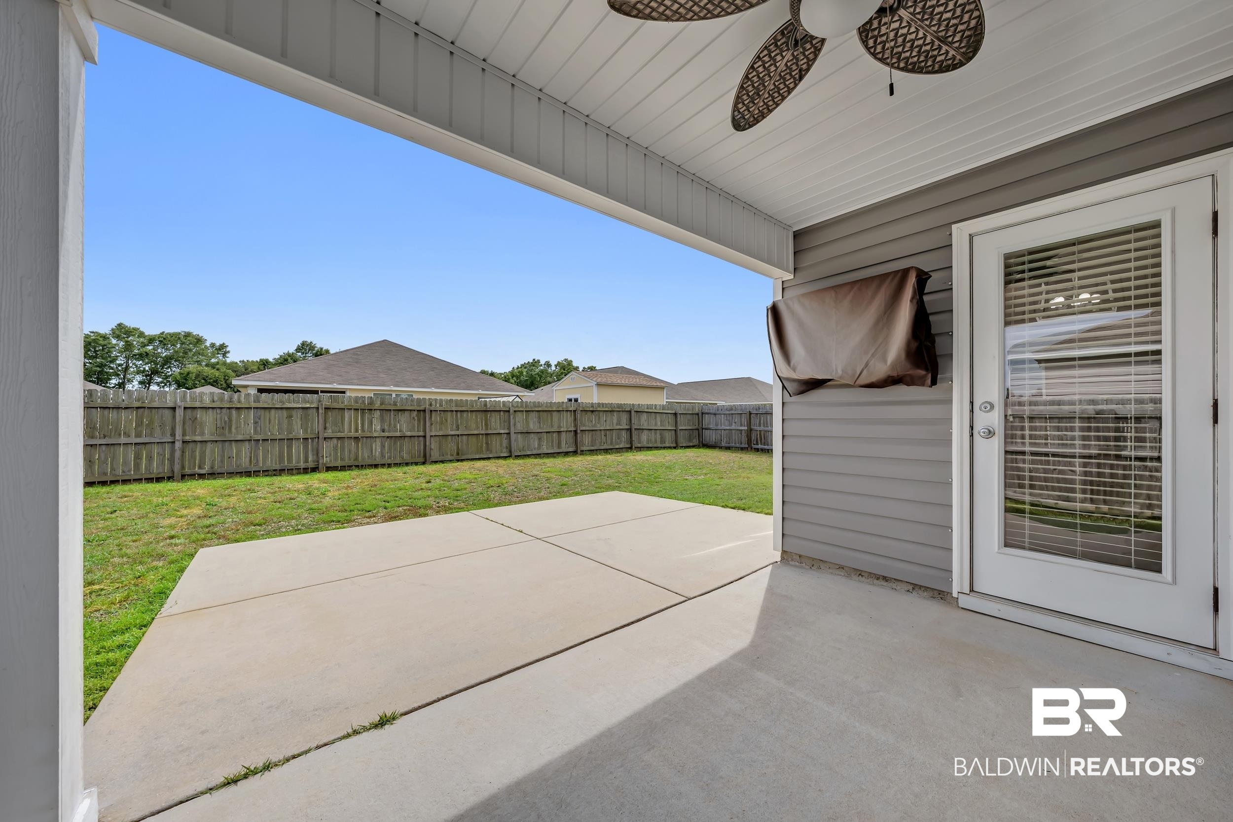 17344 Harding Drive Foley, AL 36535 - Photo 29 of 46 Covered patio featuring a ceiling fan, concrete flooring, and a private fenced yard with green lawn