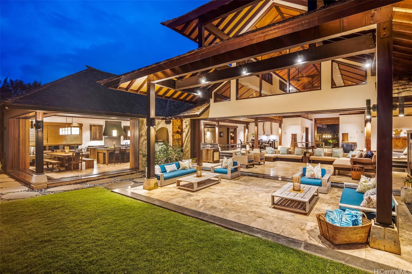 56-205 Kamehameha Highway Kahuku, HI 96731 - Photo 1 of 1 a view of a patio with table and chairs potted plants and floor to ceiling window