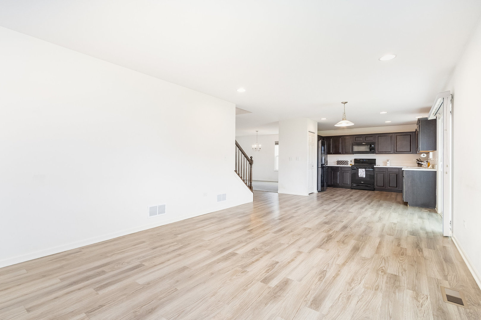 8513 Buckingham Road Joliet, IL 60431 - Photo 12 of 25 a view of a kitchen with a sink and wooden floor
