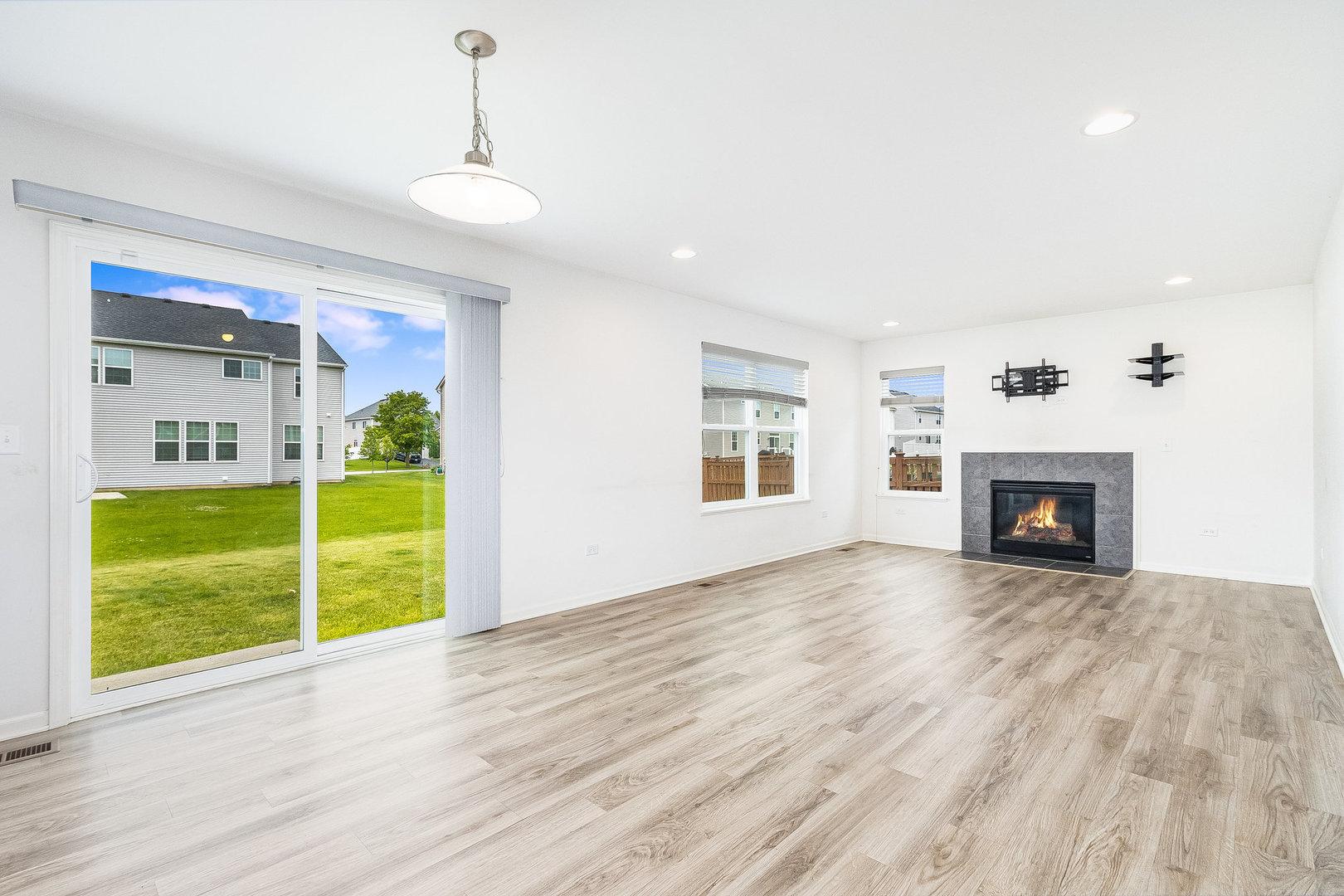 8513 Buckingham Road Joliet, IL 60431 - Photo 2 of 25 a view of an empty room with a window and fire place