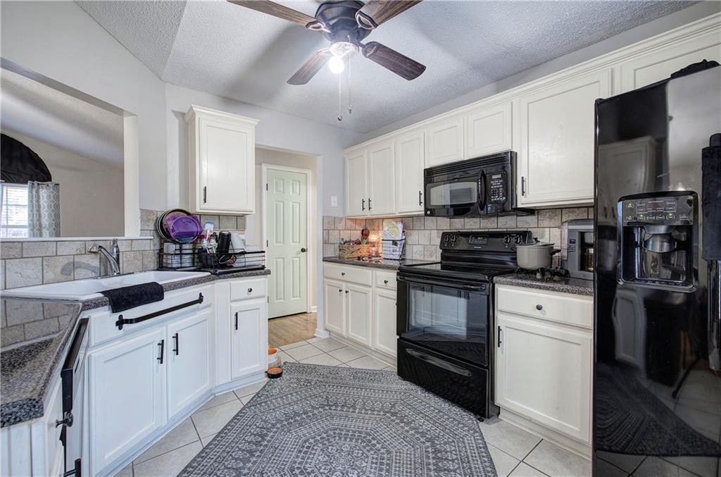 19 Canefield Drive Cartersville, GA 30120 - Photo 16 of 28 a kitchen with stainless steel appliances granite countertop a stove a sink and a refrigerator