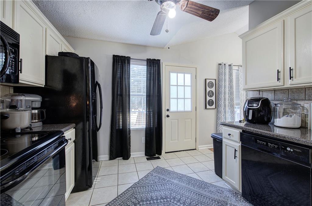 19 Canefield Drive Cartersville, GA 30120 - Photo 18 of 28 a kitchen with stainless steel appliances granite countertop a refrigerator a stove and a sink