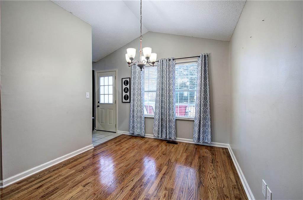 19 Canefield Drive Cartersville, GA 30120 - Photo 20 of 28 a view of a hallway with wooden floor and chandelier