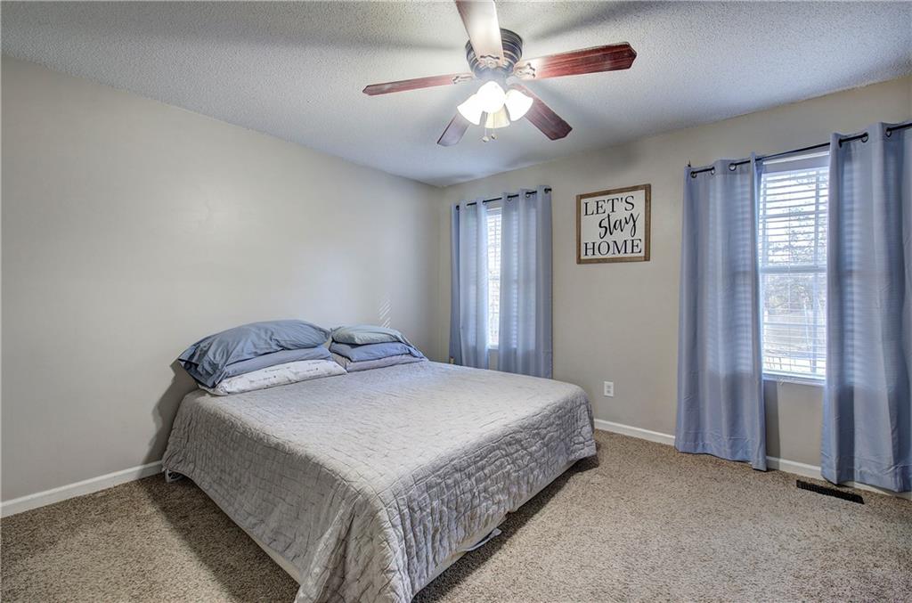 19 Canefield Drive Cartersville, GA 30120 - Photo 2 of 28 a bedroom with a bed and a chandelier