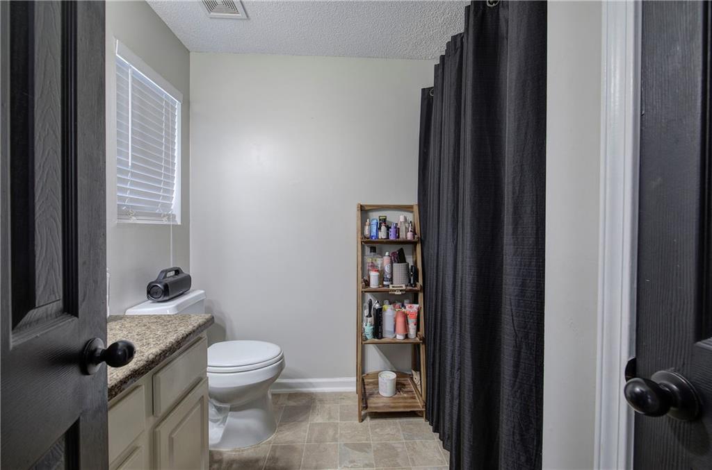 19 Canefield Drive Cartersville, GA 30120 - Photo 4 of 28 a bathroom with a toilet and a shower