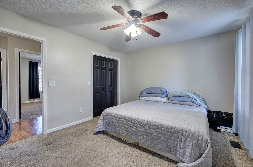 19 Canefield Drive Cartersville, GA 30120 - Photo 6 of 28 a bedroom with a bed and a chandelier