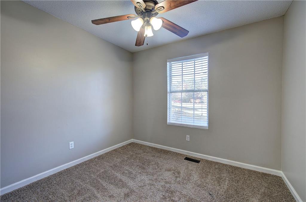19 Canefield Drive Cartersville, GA 30120 - Photo 9 of 28 an empty room with a window and a fan