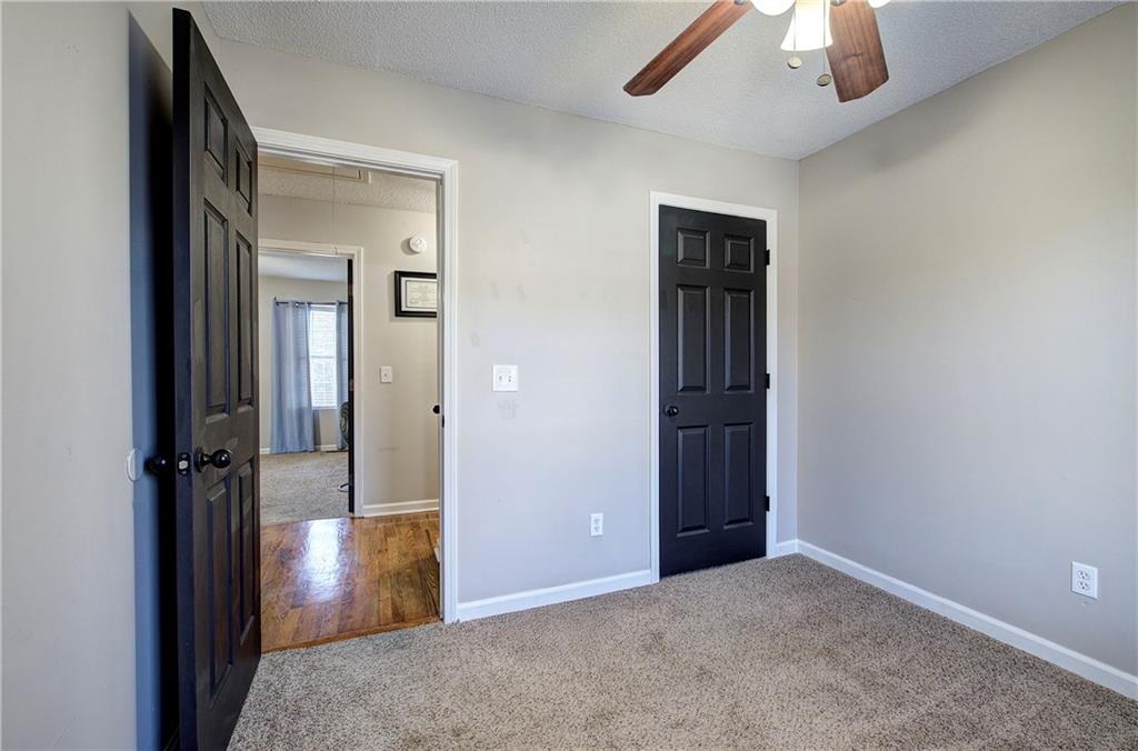 19 Canefield Drive Cartersville, GA 30120 - Photo 10 of 28 an empty room with closet and a chandelier fan