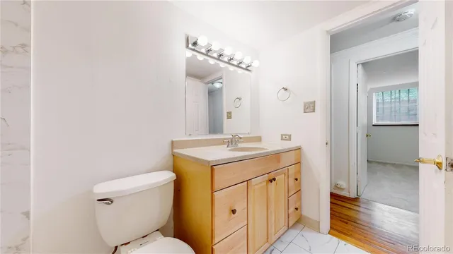 a bathroom with a sink a toilet and a mirror