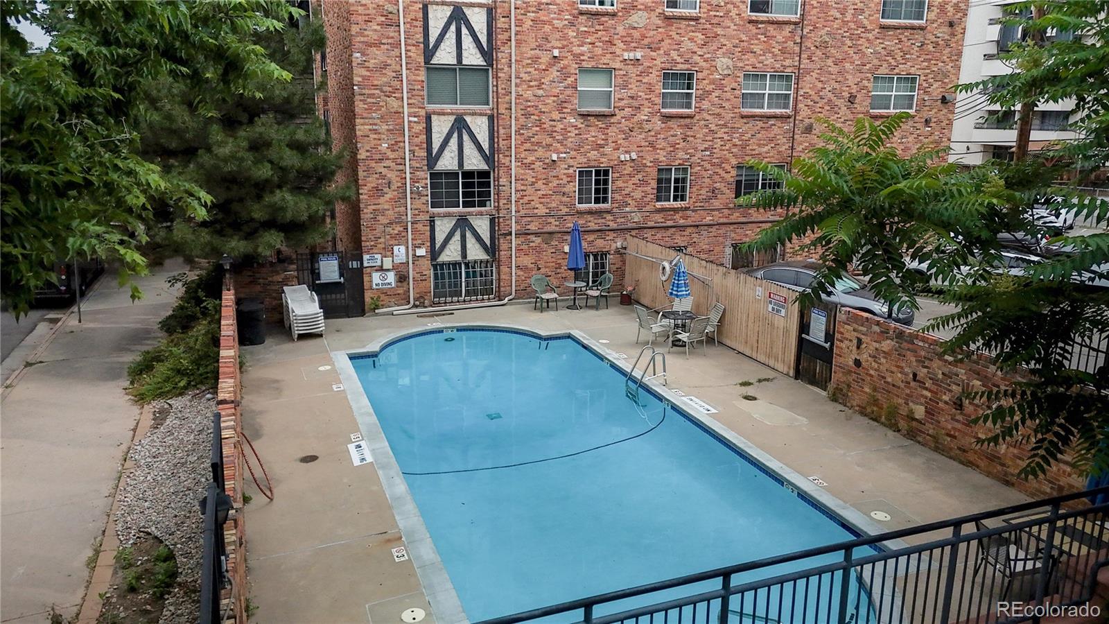 1350 Josephine Street, Unit 101A Denver, CO 80206 - Photo 25 of 36 a view of a balcony with chairs and potted plants