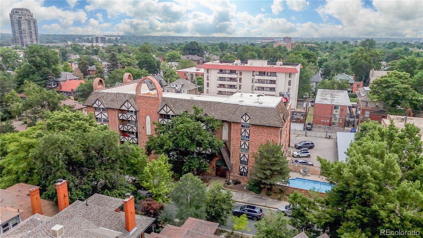 1350 Josephine Street, Unit 101A Denver, CO 80206 - Photo 27 of 36 an aerial view of a city with lots of residential buildings ocean and mountain view in back