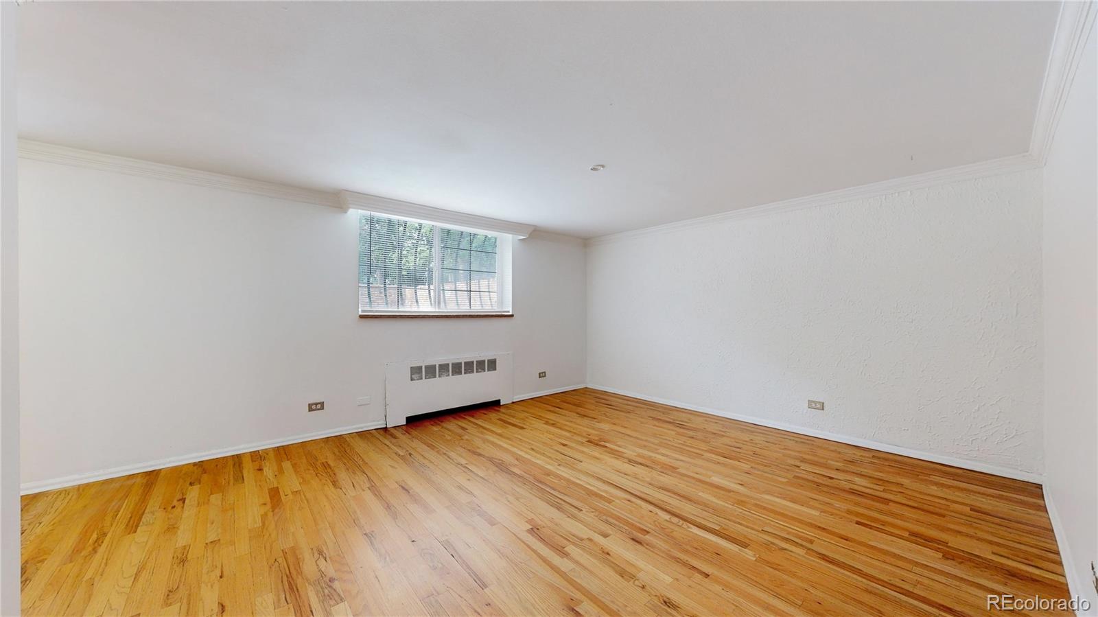 1350 Josephine Street, Unit 101A Denver, CO 80206 - Photo 4 of 36 an empty room with wooden floor and windows