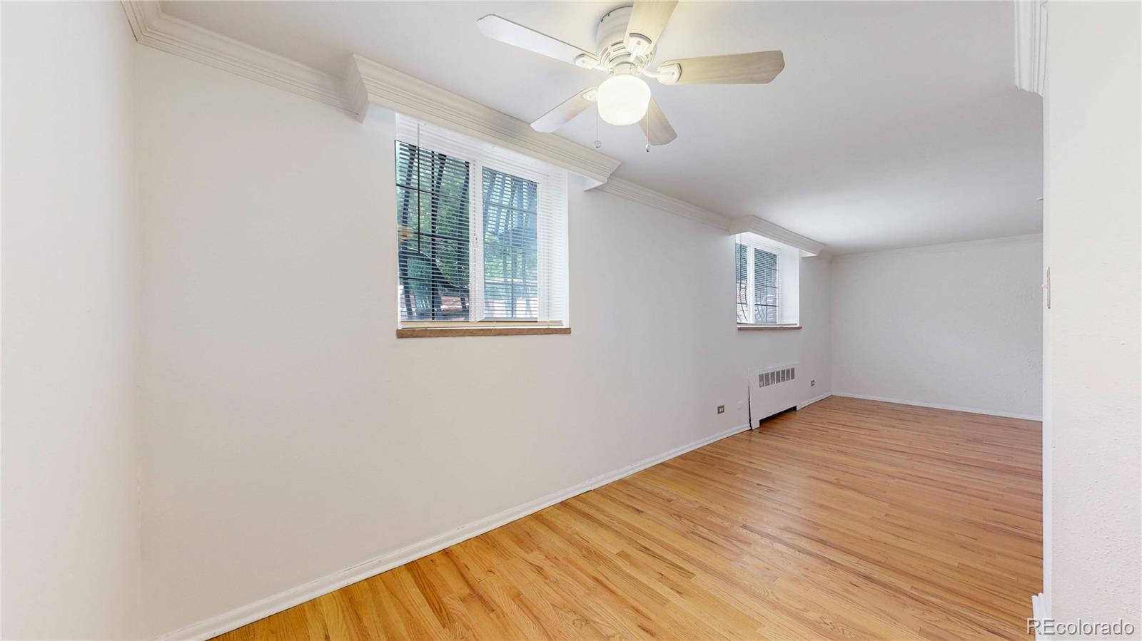 1350 Josephine Street, Unit 101A Denver, CO 80206 - Photo 9 of 36 an empty room with windows and fan