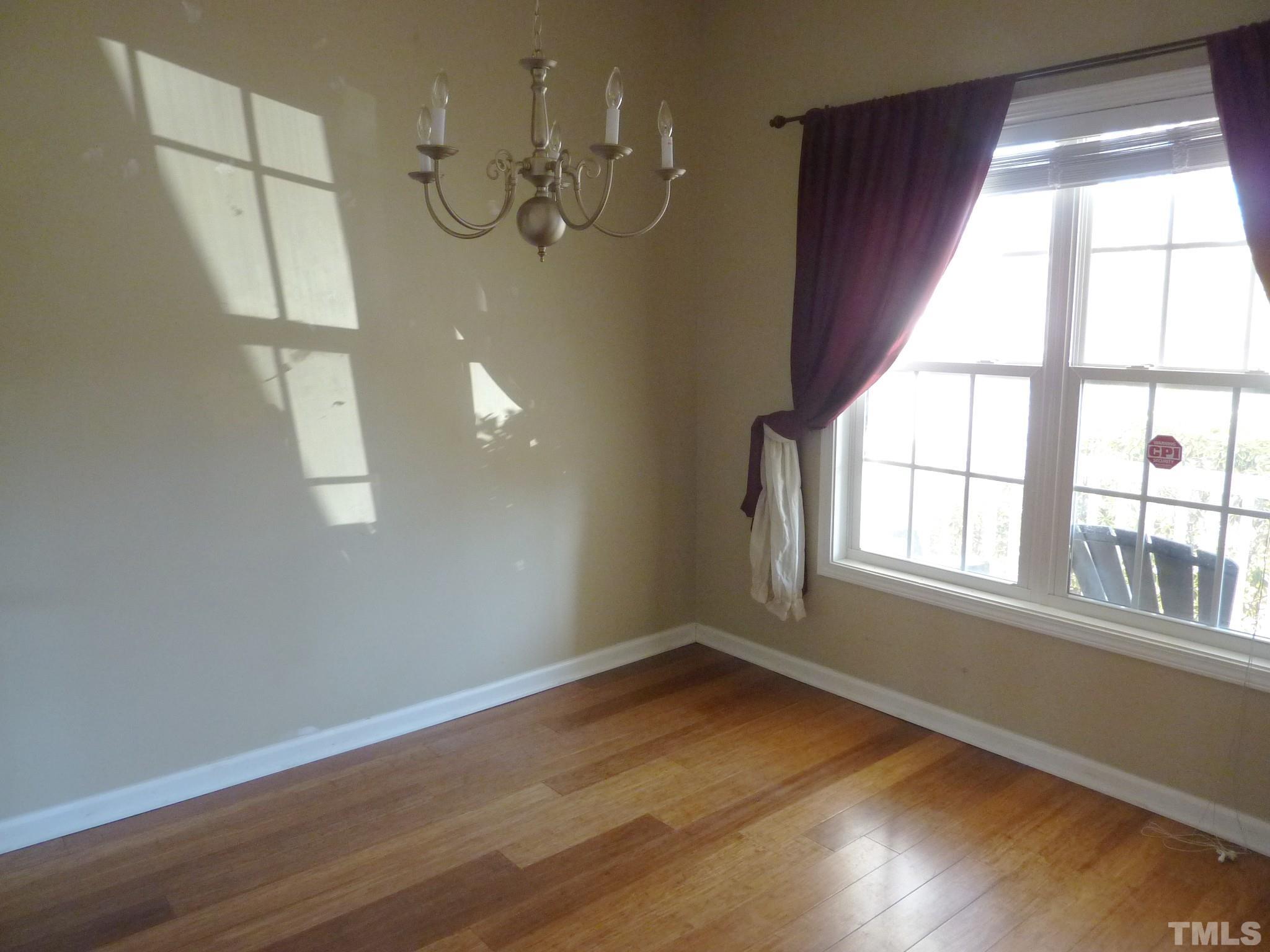 5943 Brambleberry Way Raleigh, NC 27616 - Photo 2 of 12 Separate dining room with wood laminate flooring and large double window!