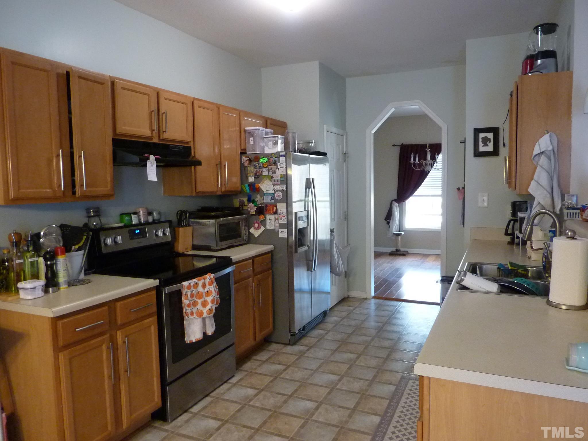 5943 Brambleberry Way Raleigh, NC 27616 - Photo 3 of 12 Spacious kitchen with eat-in breakfast area. Good size pantry and track lighting!