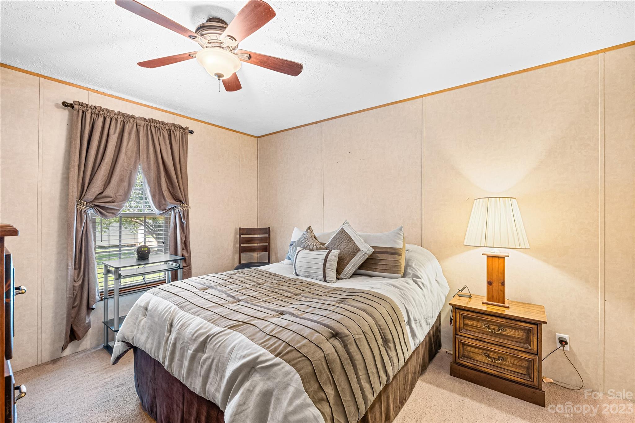 137 Brook Road Kings Mountain, NC 28086 - Photo 25 of 46 a bedroom with a bed and a chandelier