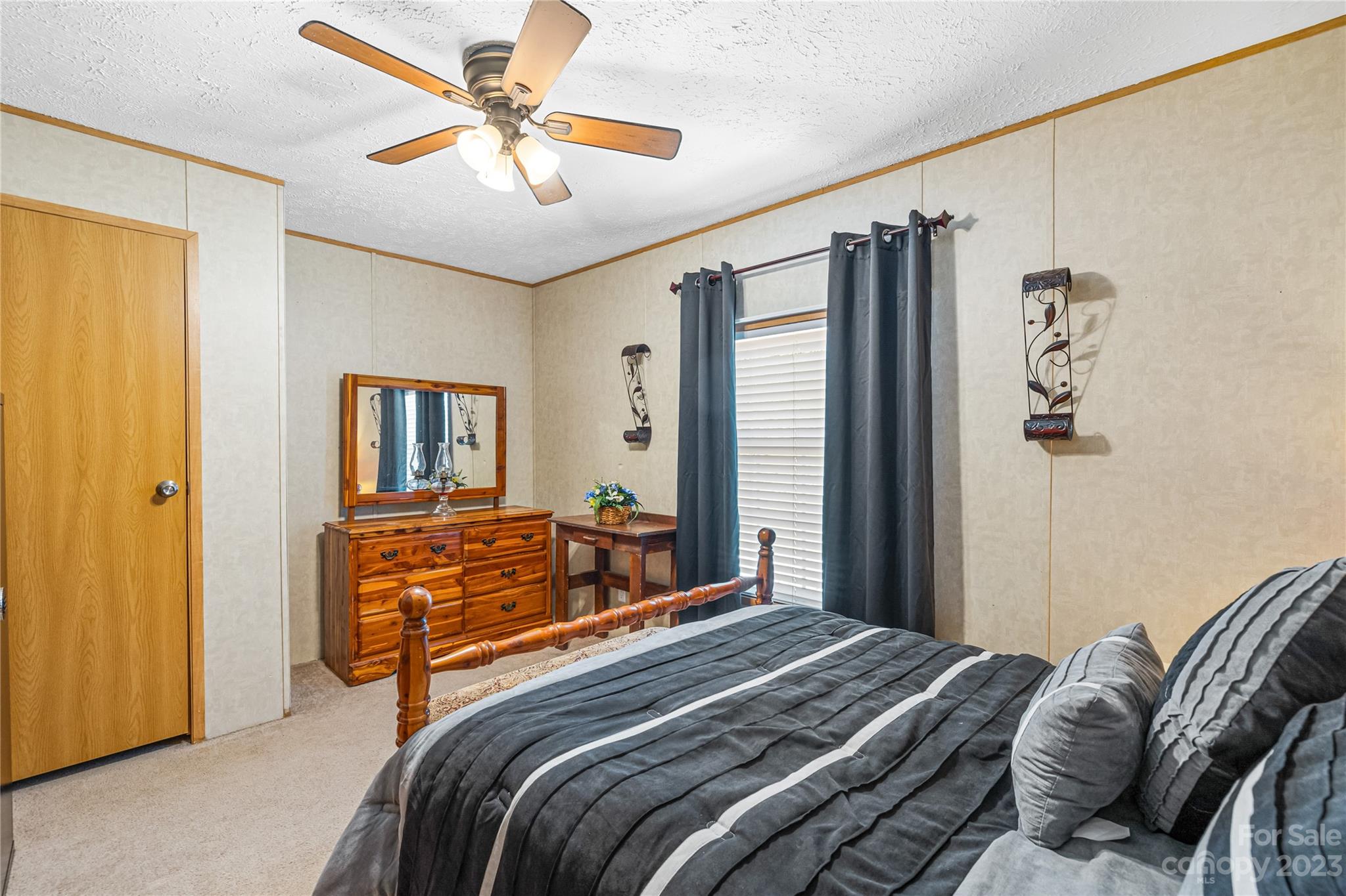 137 Brook Road Kings Mountain, NC 28086 - Photo 26 of 46 a bedroom with a bed and a chandelier