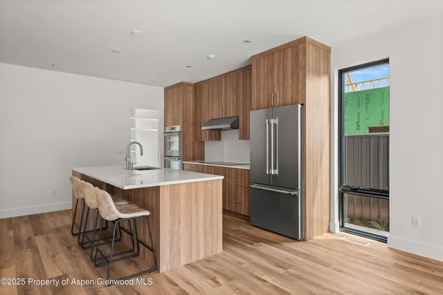 a kitchen with kitchen island a counter top space appliances and cabinets