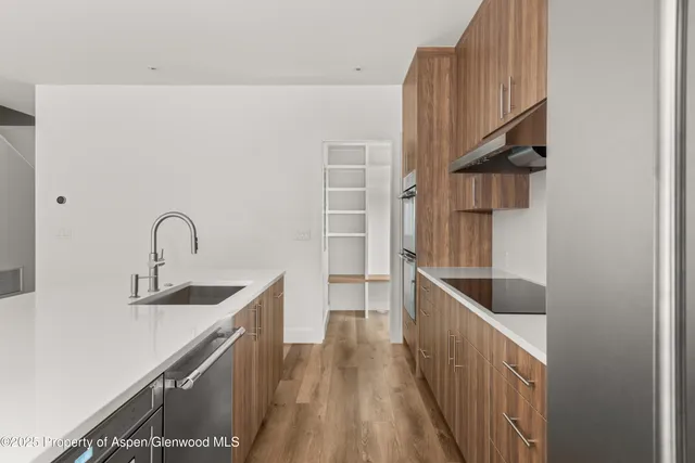a kitchen with a sink and a stove top oven