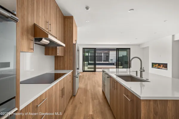 a kitchen with a sink and a stove top oven