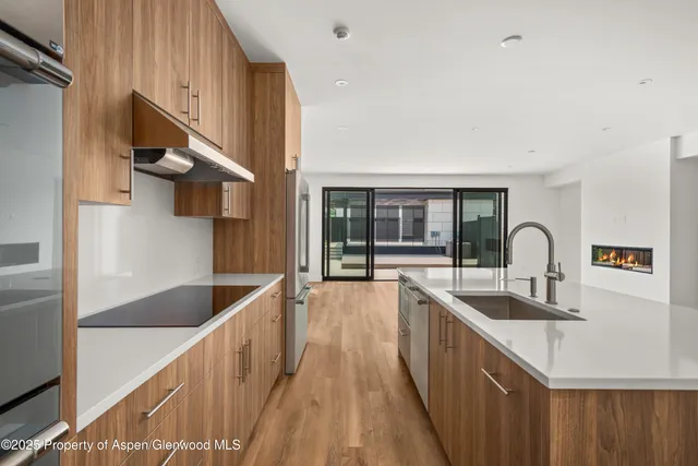 a kitchen with a sink and a stove top oven